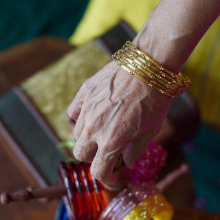 Amaltas | Golden Stone Studded Glass Bangles (Set of 12) | Kanchan 2024