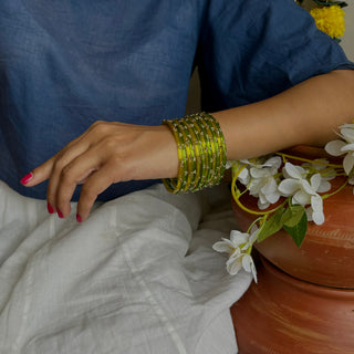 Sukusum Aur Surajmukhi Stone Studded Glass Bangle Stack (Set of 12) | Yellow & Green