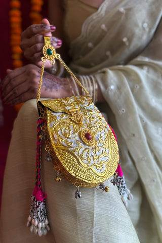 The Phoolwari Brass Clutch | Handcrafted Gold-Silver Bag with Tribal Hangings